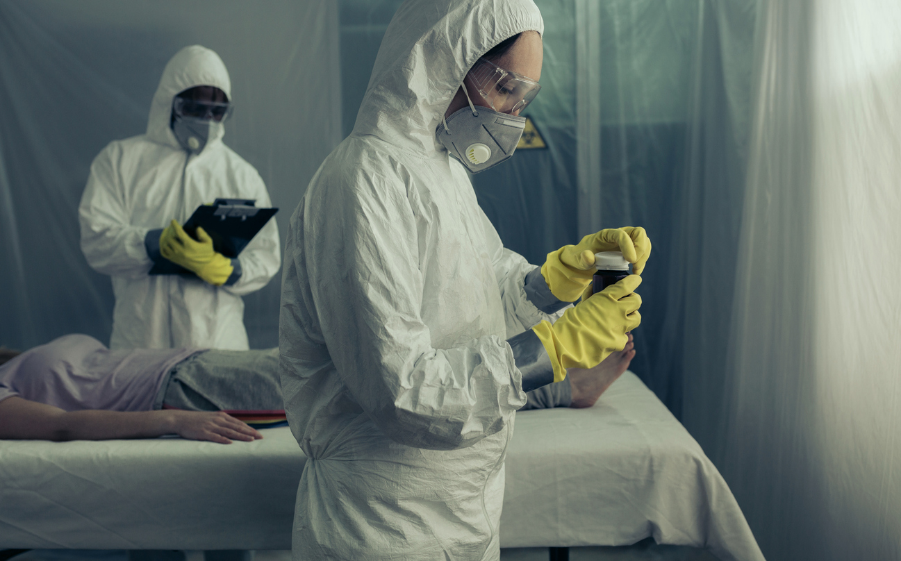 Doctors preparing medication for sick woman